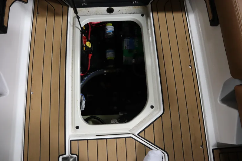 Slide: The Image of 2023 Nautique Super Air Nautique G23 engine compartment with teak flooring. - 21