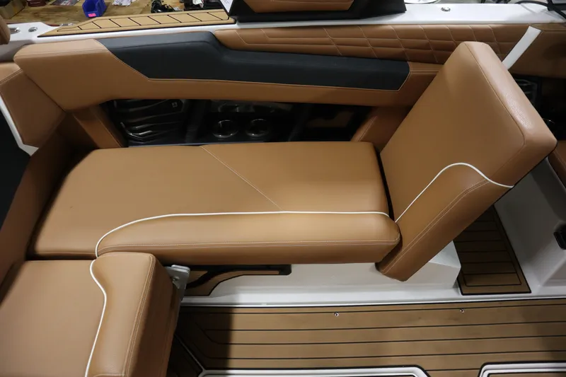 Slide: The Image of 2023 Nautique Super Air Nautique G23 interior with tan leather seating and sleek design. - 22