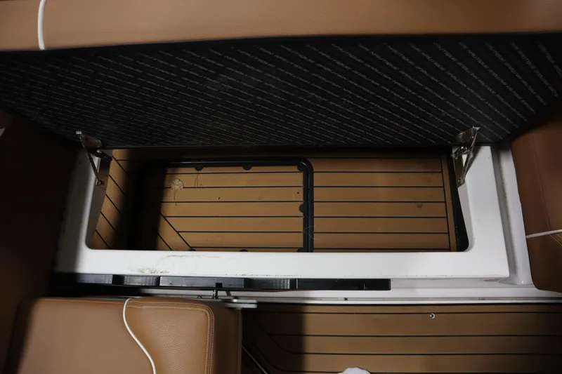 Slide: The Image of 2023 Nautique Super Air Nautique G23 storage compartment with open lid, showcasing interior space. - 23