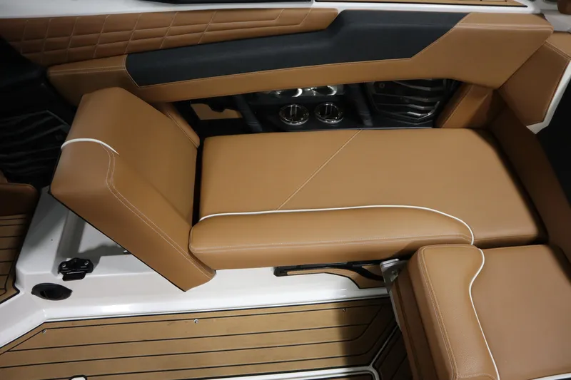 Slide: The Image of 2023 Nautique Super Air Nautique G23 interior seating with tan upholstery and modern design. - 25