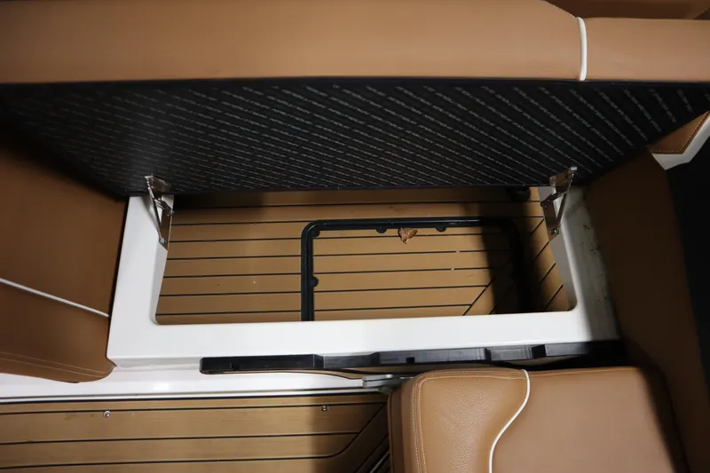 Slide: The Image of 2023 Nautique Super Air Nautique G23 storage compartment with open lid, showcasing interior design. - 26