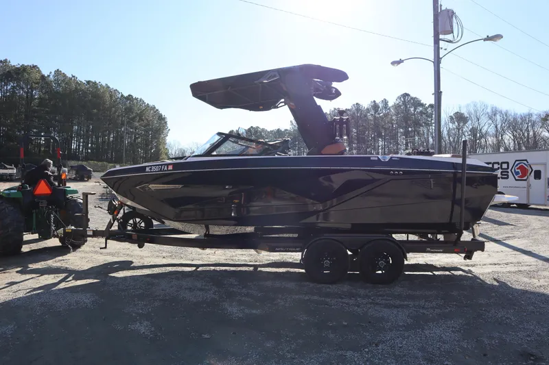 Slide: The Image of 2023 Nautique Super Air Nautique G23 boat on trailer, parked outdoors. - 3