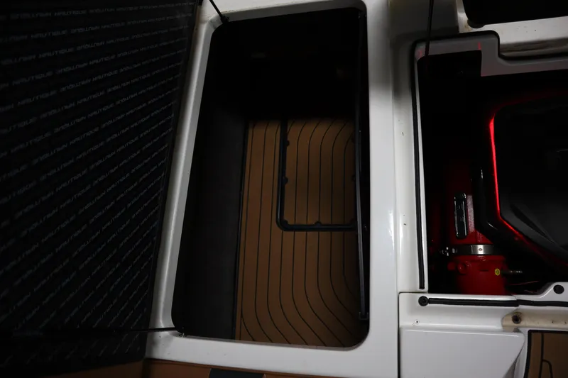 Slide: The Image of 2023 Nautique Super Air Nautique G23 interior storage and engine compartment. - 30