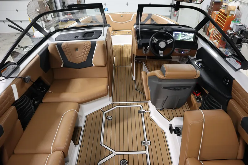 Slide: The Image of 2023 Nautique Super Air Nautique G23 interior with tan leather seats and modern dashboard. - 31