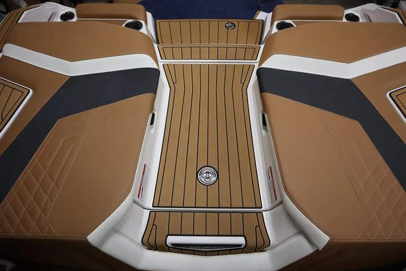 Slide: The Image of 2023 Nautique Super Air Nautique G23 boat interior with tan and black upholstery. - 32