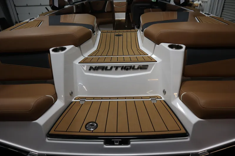 Slide: The Image of 2023 Nautique Super Air Nautique G23 boat interior with tan seating and teak flooring. - 37