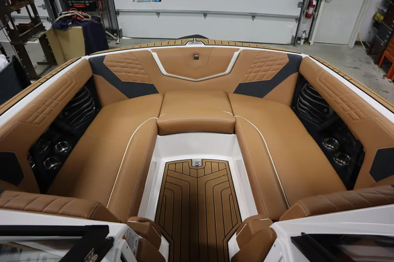 Slide: The Image of 2023 Nautique Super Air Nautique G23 boat interior with tan leather seating. - 4