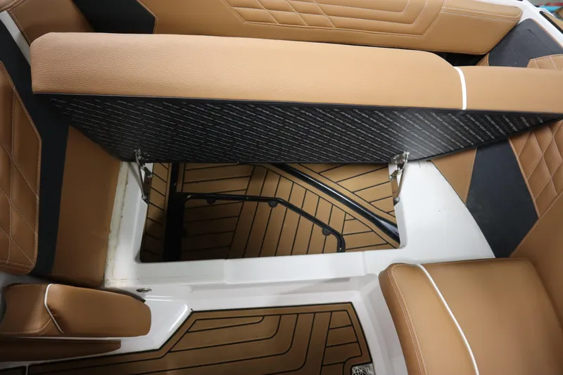Slide: The Image of 2023 Nautique Super Air Nautique G23 interior storage compartment with tan seating. - 6