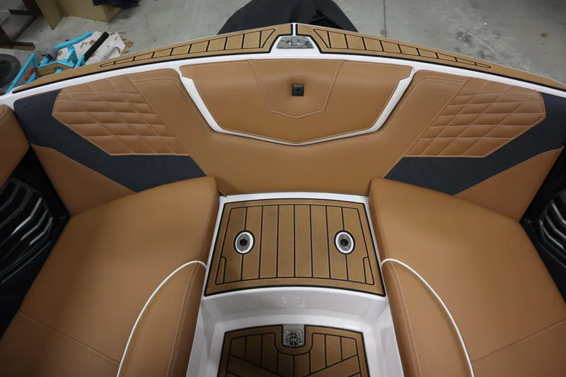 Slide: The Image of 2023 Nautique Super Air Nautique G23 interior with tan and black upholstery. - 7