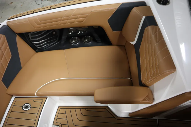 Slide: The Image of 2023 Nautique Super Air Nautique G23 interior with tan leather seating and cup holders. - 8