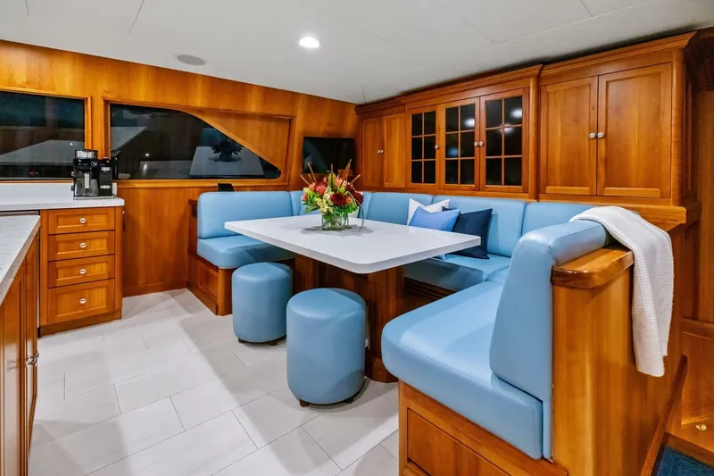 Slide: The Image of Luxurious 1998 Burger Raised Pilothouse yacht interior with elegant dining area and wooden cabinetry. - 11