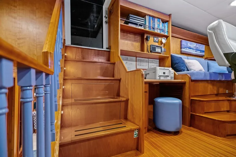 Slide: The Image of Luxurious interior of 1998 Burger Raised Pilothouse yacht with wooden stairs and seating area. - 12