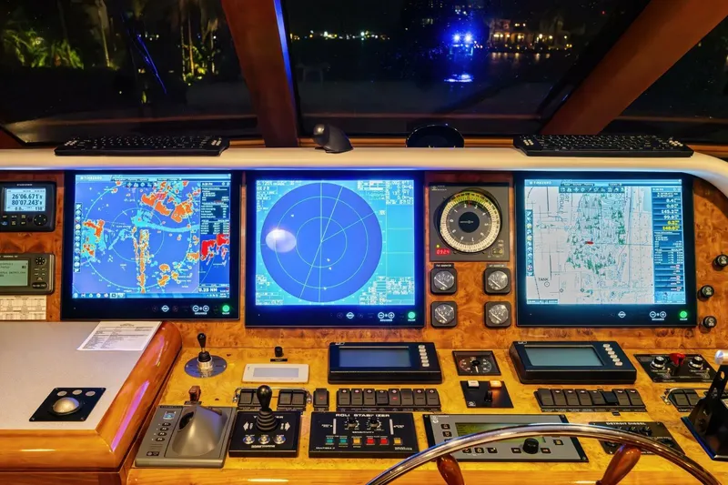 Slide: The Image of Cockpit of 1998 Burger Raised Pilothouse yacht with navigation screens and controls. - 16