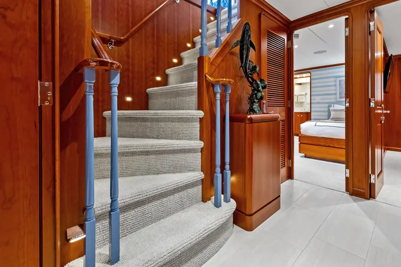 Slide: The Image of Luxurious interior of a 1998 Burger Raised Pilothouse yacht with elegant staircase and bedroom. - 18