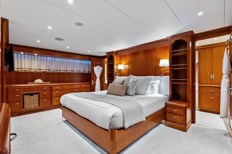 Slide: The Image of Luxurious 1998 Burger Raised Pilothouse yacht bedroom with elegant wood finishes and plush bedding. - 21