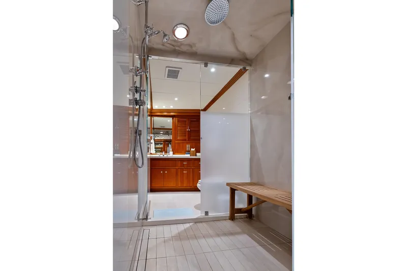 Slide: The Image of Luxurious shower area on 1998 Burger Raised Pilothouse yacht with wooden bench and modern fixtures. - 22