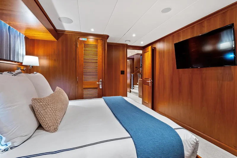 Slide: The Image of Luxurious cabin interior of 1998 Burger Raised Pilothouse yacht with wood paneling and modern amenities. - 25