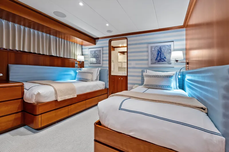 Slide: The Image of Luxurious twin bedroom in 1998 Burger Raised Pilothouse yacht, featuring elegant wood and nautical decor. - 27