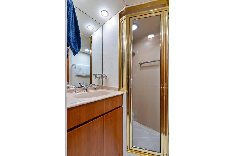Slide: The Image of Luxurious bathroom in 1998 Burger Raised Pilothouse yacht with gold-framed shower and elegant fixtures. - 37