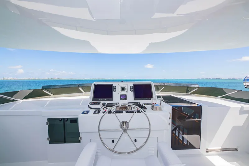 Slide: The Image of Raised Pilothouse yacht helm with ocean view, featuring modern navigation equipment, 1998 Burger model. - 43