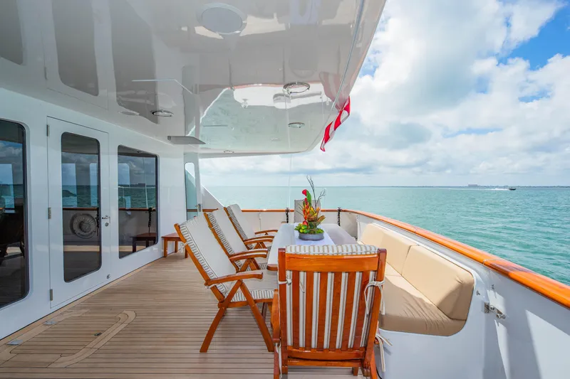 Slide: The Image of Luxurious deck of 1998 Burger Raised Pilothouse yacht with ocean view and elegant seating. - 46