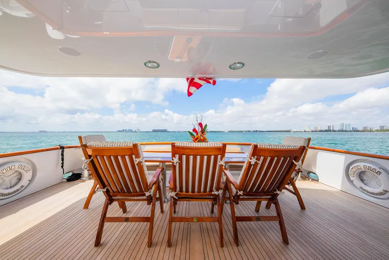 Slide: The Image of Luxury yacht deck with wooden chairs overlooking ocean, Burger Raised Pilothouse 1998. - 47