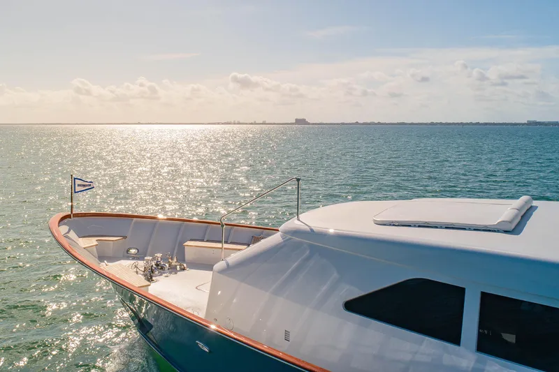 Slide: The Image of Luxurious 1998 Burger Raised Pilothouse yacht cruising on serene waters under a sunny sky. - 54