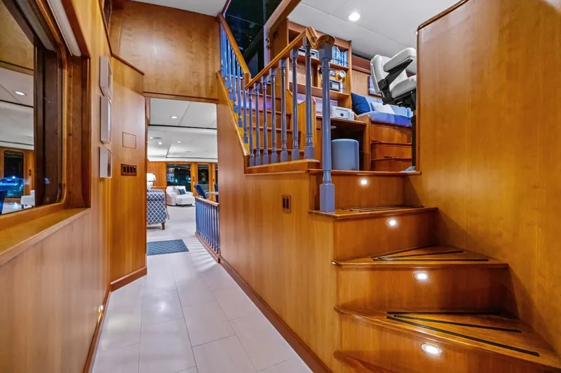 Slide: The Image of Luxurious 1998 Burger Raised Pilothouse yacht interior with wooden staircase and elegant furnishings. - 7