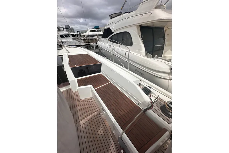 Slide: The Image of 2025 Beneteau Oceanis 46.1 yacht with sleek deck design in marina setting. - 11