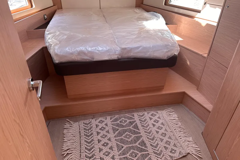 Slide: The Image of Luxurious cabin interior of 2025 Beneteau Oceanis 46.1 yacht with cozy bed and elegant decor. - 18