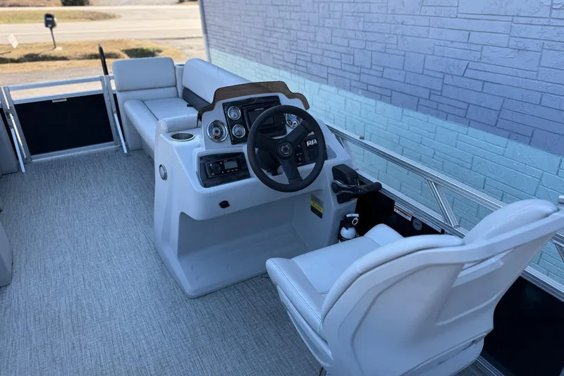 Slide: The Image of 2021 Avalon VTX Cruise 18' boat interior with steering console and seating. - 5