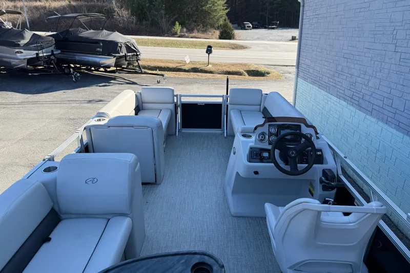 Slide: The Image of 2021 Avalon VTX Cruise 18' pontoon boat interior with seating and steering console. - 7