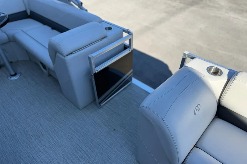 Slide: The Image of 2021 Avalon VTX Cruise 18' boat interior with gray seating and cup holders. - 8