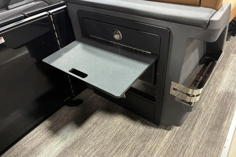 Slide: The Image of 2026 Bennington 23 MSL boat interior with fold-out table and storage compartment. - 10