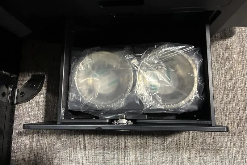 Slide: The Image of Storage compartment in 2026 Bennington 23 MSL boat, containing wrapped items. - 7