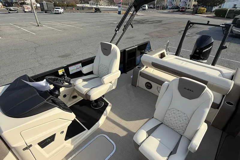Slide: The Image of Interior of 2026 Alera M23L boat with modern seating and steering console. - 10