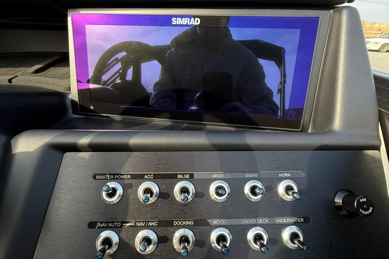 Slide: The Image of Control panel of Alera M23L 2026 with Simrad display and various switches. - 14