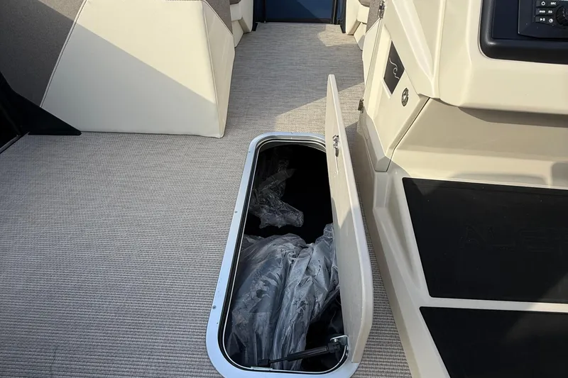 Slide: The Image of Open storage compartment in 2026 Alera M23L boat interior. - 15