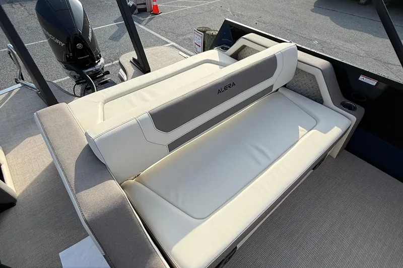 Slide: The Image of 2026 Alera M23L boat interior with cushioned seating and Mercury outboard motor. - 18