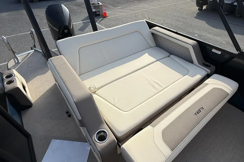 Slide: The Image of 2026 Alera M23L boat interior with beige seating and cup holders. - 19
