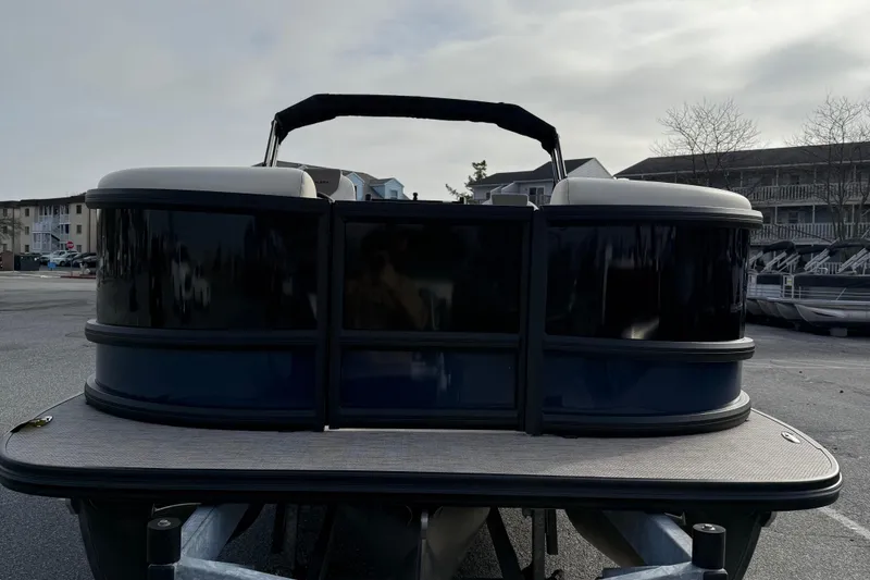 Slide: The Image of 2026 Alera M23L pontoon boat parked in a marina lot. - 3