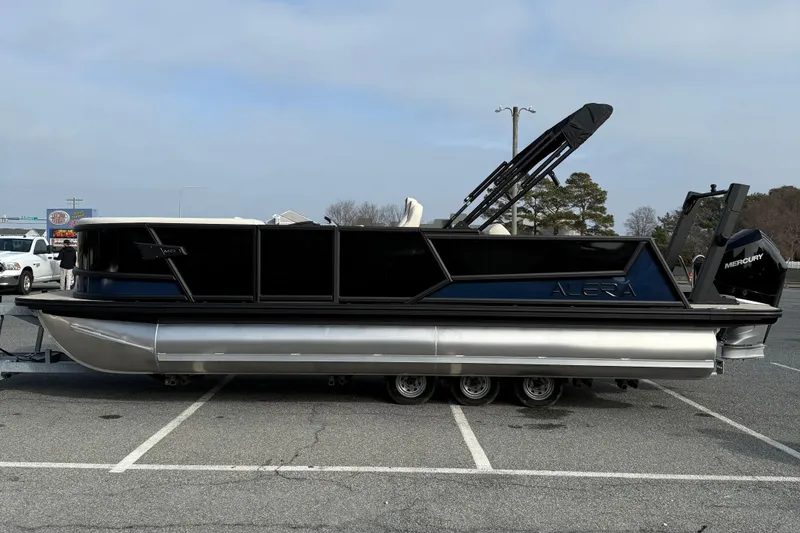 Slide: The Image of 2026 Alera M23L pontoon boat parked in a lot, featuring sleek design and Mercury engine. - 5