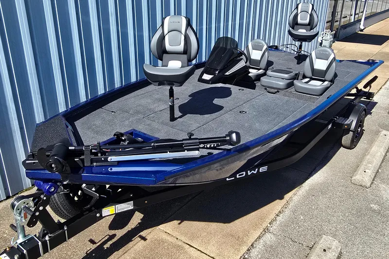 Slide: The Image of 2026 Lowe Stinger 195 Bass boat with seating, parked on a trailer. - 11