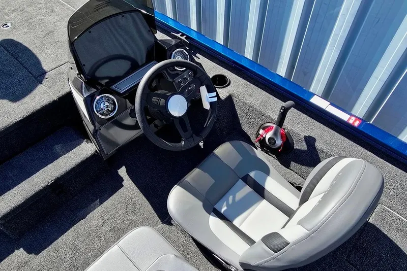 Slide: The Image of 2026 Lowe Stinger 195 Bass boat interior with steering wheel and seat. - 2