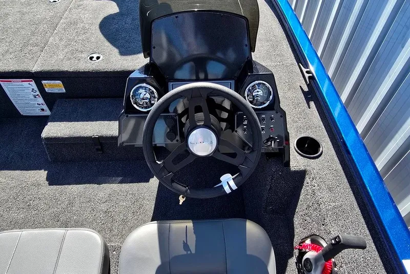 Slide: The Image of 2026 Lowe Stinger 195 Bass boat cockpit with steering wheel and control panel. - 9