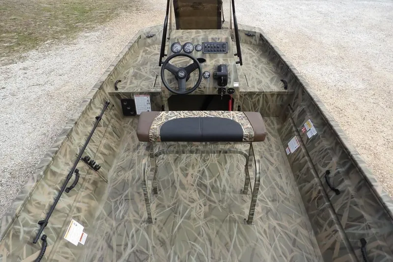 Slide: The Image of 2026 Crestliner 1870 Retriever FCC boat interior with camouflage design and steering console. - 14