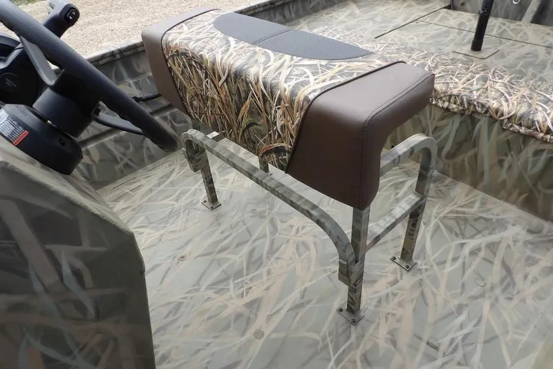 Slide: The Image of 2026 Crestliner 1870 Retriever FCC boat interior with camo seat and steering wheel. - 15