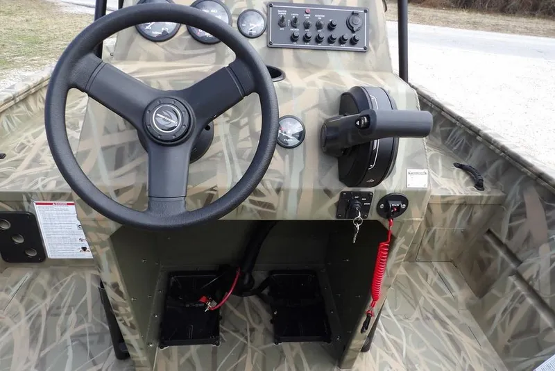 Slide: The Image of 2026 Crestliner 1870 Retriever FCC boat console with steering wheel and control panel. - 17