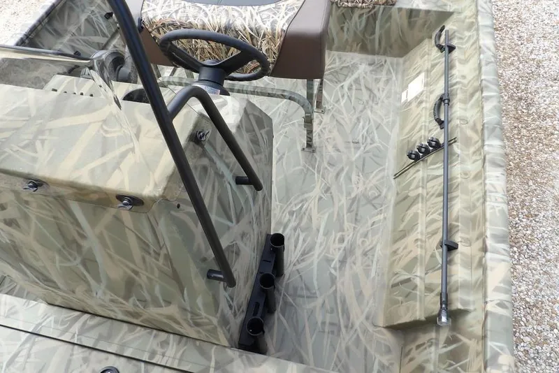 Slide: The Image of 2026 Crestliner 1870 Retriever FCC boat interior with camouflage design and steering console. - 20