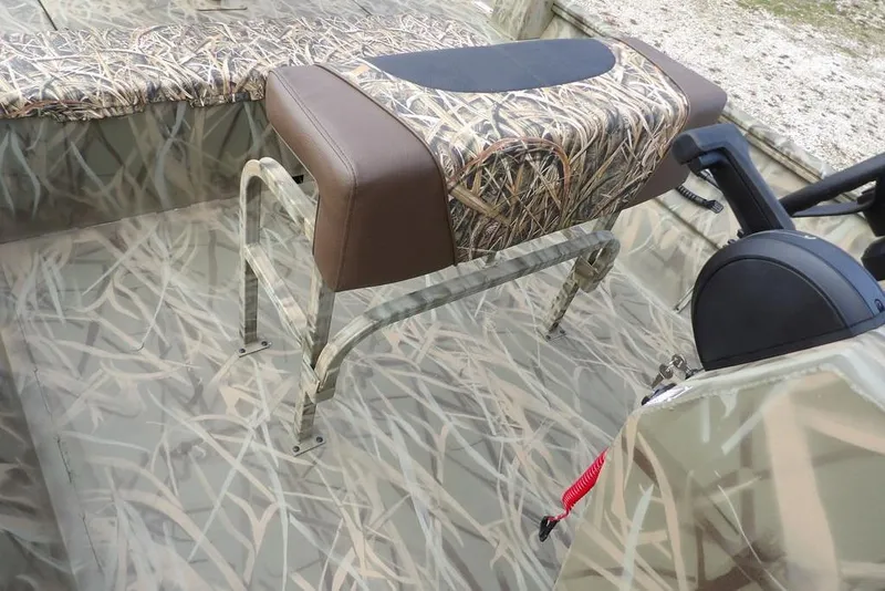 Slide: The Image of 2026 Crestliner 1870 Retriever FCC boat interior with camouflage seating and steering console. - 23